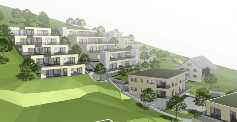 Aerial view of a residential building complex with multiple buildings, balconies, and green spaces