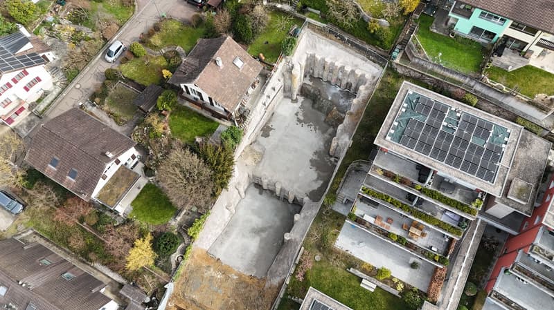 aerial view, construction site with swimming pool, 3 adjacent houses, solar panels, fenced area, greenery