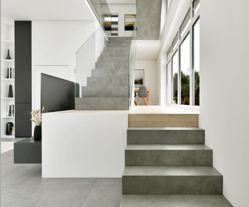 modern house with concrete and glass, large steps, glass railing