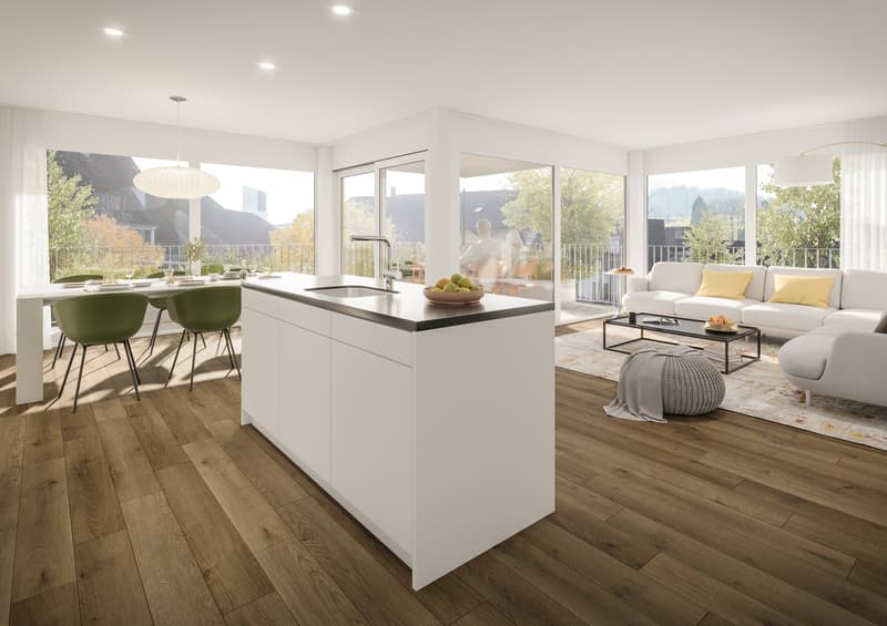 Kitchen with large white island and modern appliances, dining area with table and chairs, living area with white sofa and large windows leading to a balcony