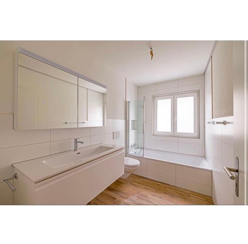Bathroom with shower, bathtub, toilet, sink, cabinets, mirror, and tiled walls