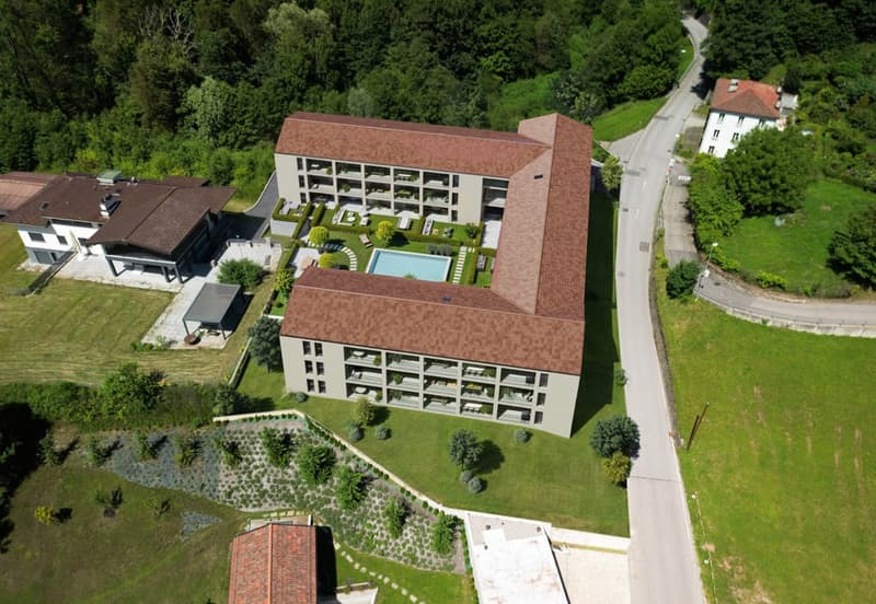2-storey building, rectangular swimming pool, surrounded by lush green landscape