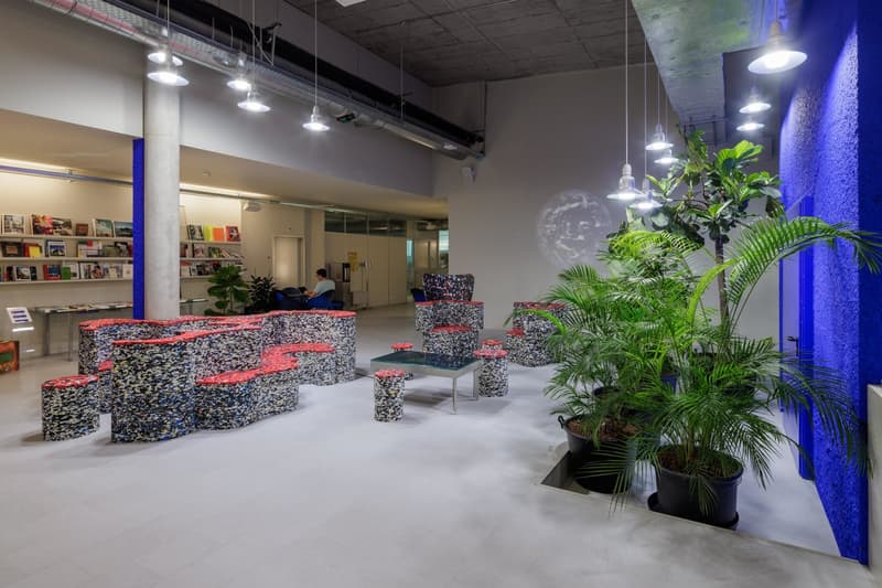 Reception area with tables and seating made from recycled plastic, wall art, plants
