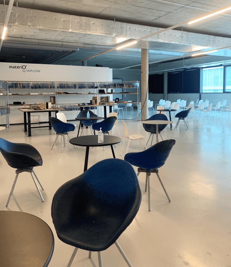 Meeting room, modern design, circular tables, round chairs, shelves with various items