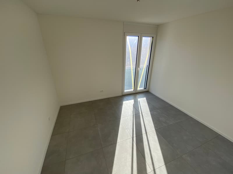 empty room, white walls, gray tiled floor, sliding glass door