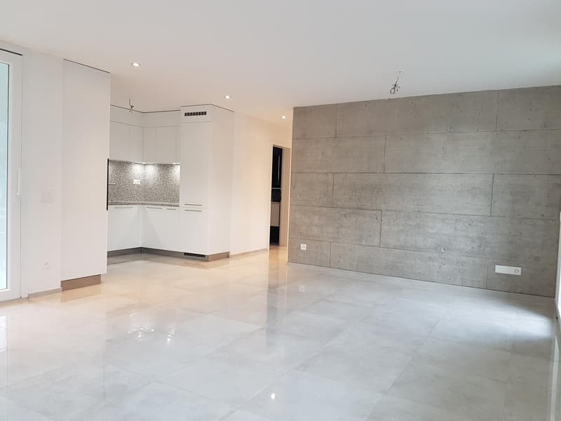 empty room, white walls, white floor, white kitchen cabinets, concrete wall