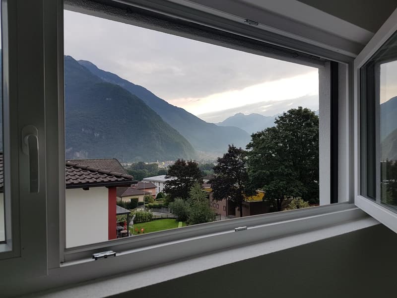 Window view of mountains and buildings