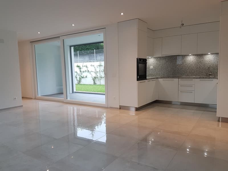 kitchen area with dining table, sliding doors to terrace, granite countertop, white cabinets, modern lighting