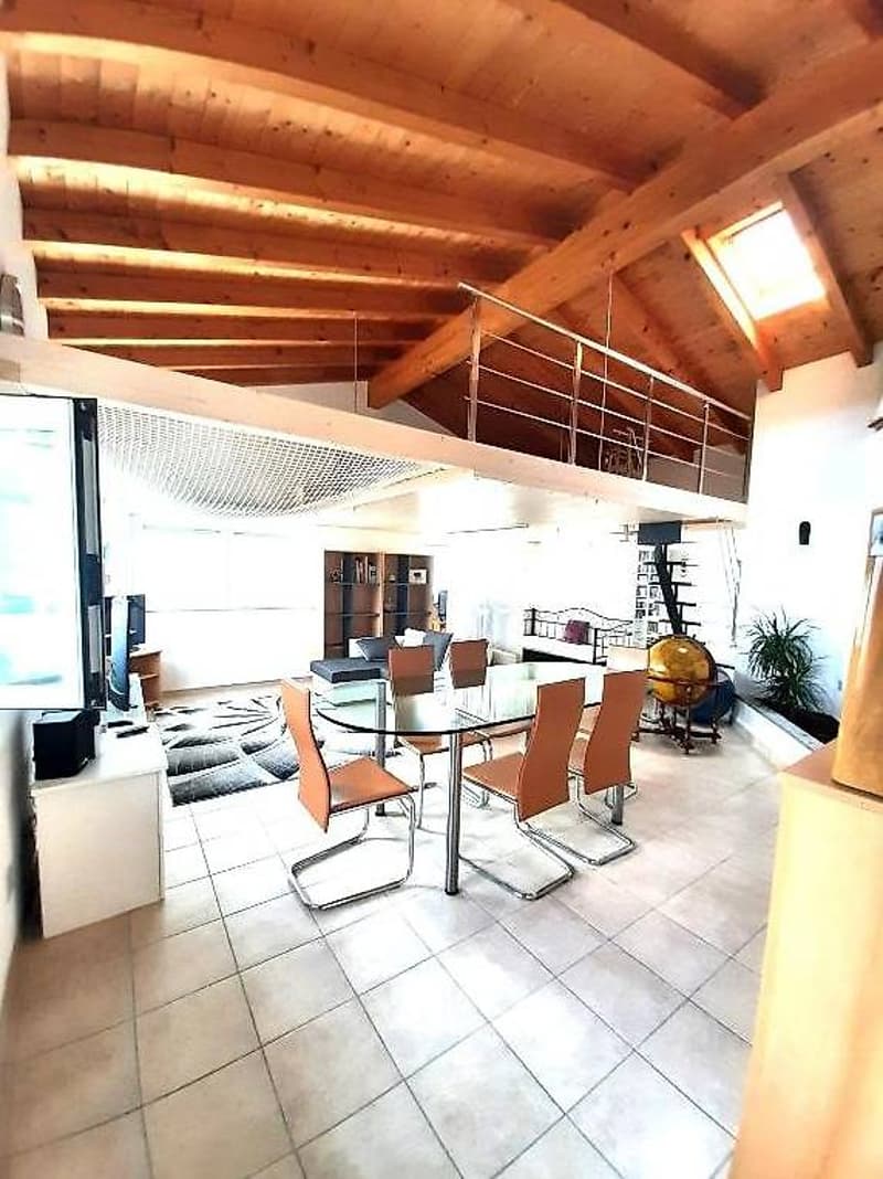 open floor plan, wooden beams, tile flooring, glass table, balcony, stairs, rug, TV, sofa, bookshelf