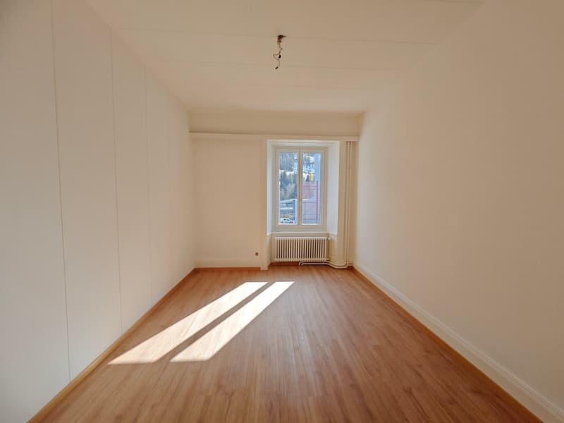 empty room, wooden floor, white walls, window with white frame, white radiator