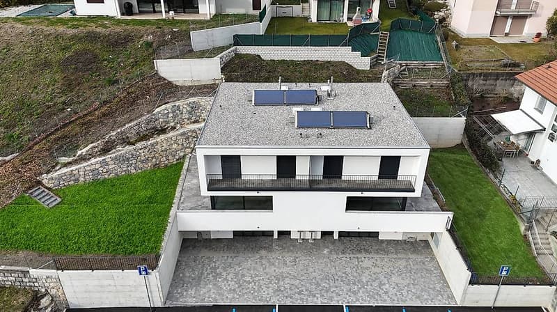 Modern house with raised ground floor, solar panels, balcony, garage, parking place, swimming pool