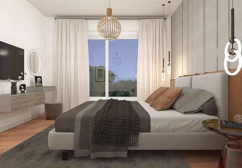 Modern bedroom with white walls, gray bed, pillows, blankets, lamp, TV, oval mirror, nightstand, stool, and side table