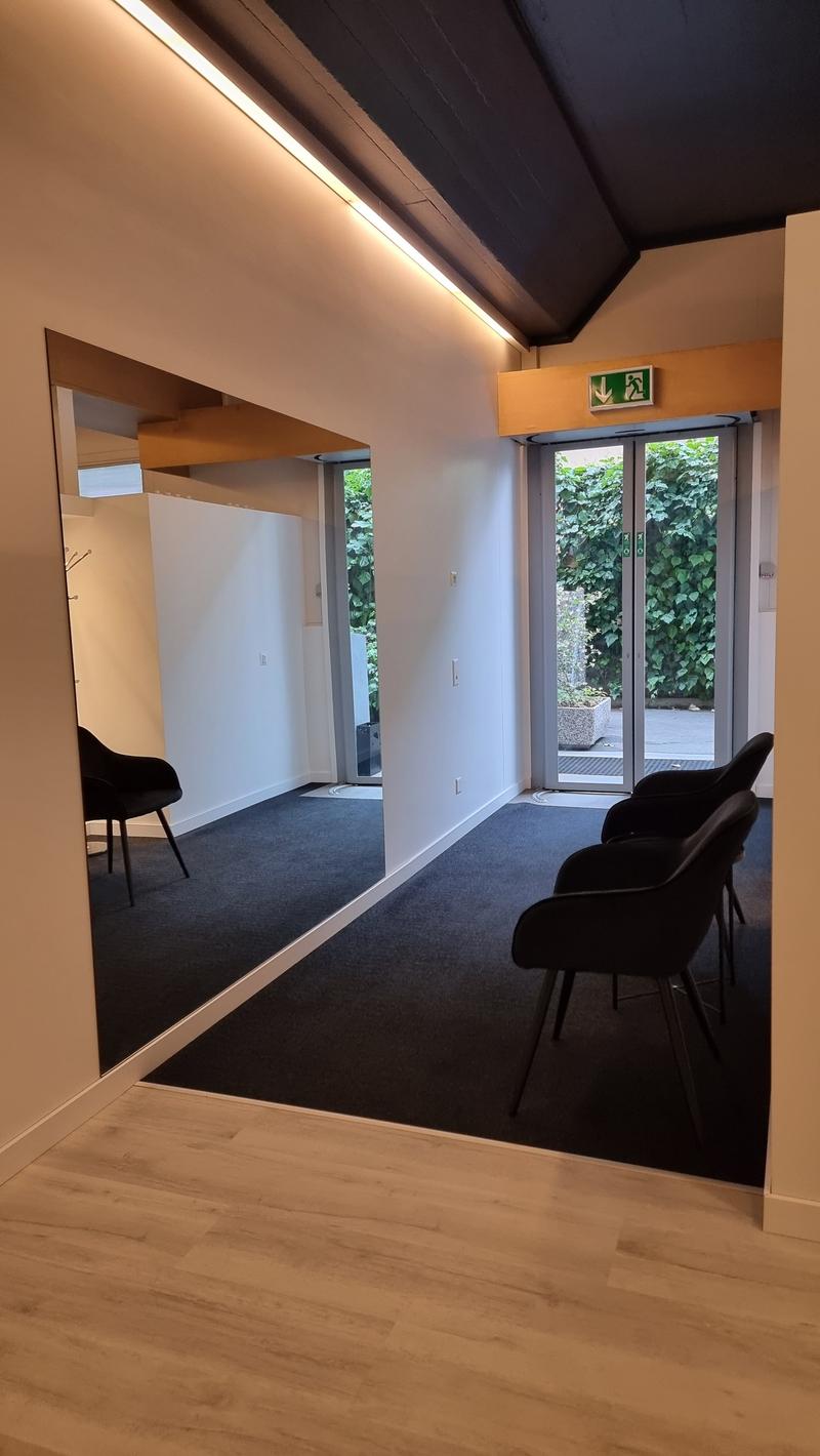 wooden floor, white walls, black carpet, a mirror, glass doors