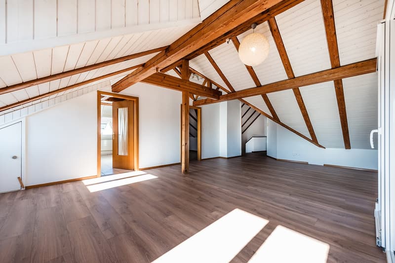 Exposed wooden beams, wooden floor, open doors, sunlight
