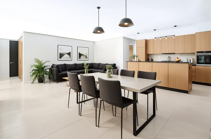 dining room with a long table and chairs, living room with a couch, open kitchen, potted plants