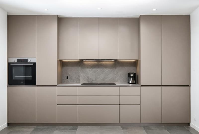 Modern fitted kitchen with integrated appliances and wooden flooring