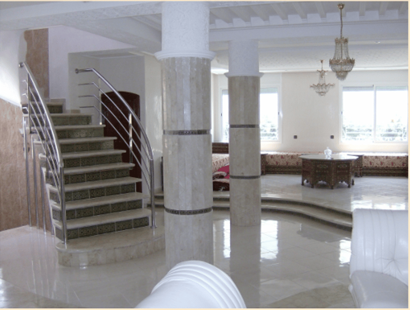 Marble staircase, white tile floor, marble columns, chandeliers, white sofa