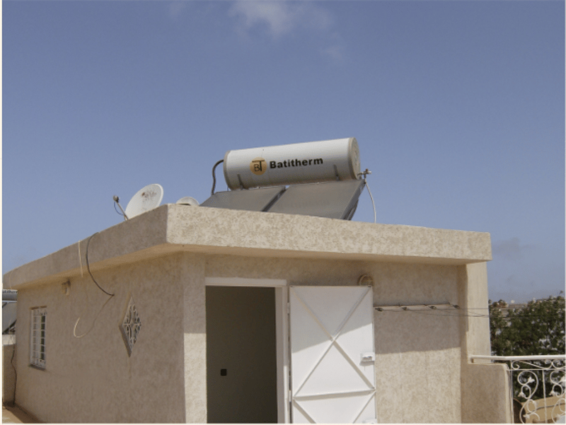 small house with a solar panel on the roof