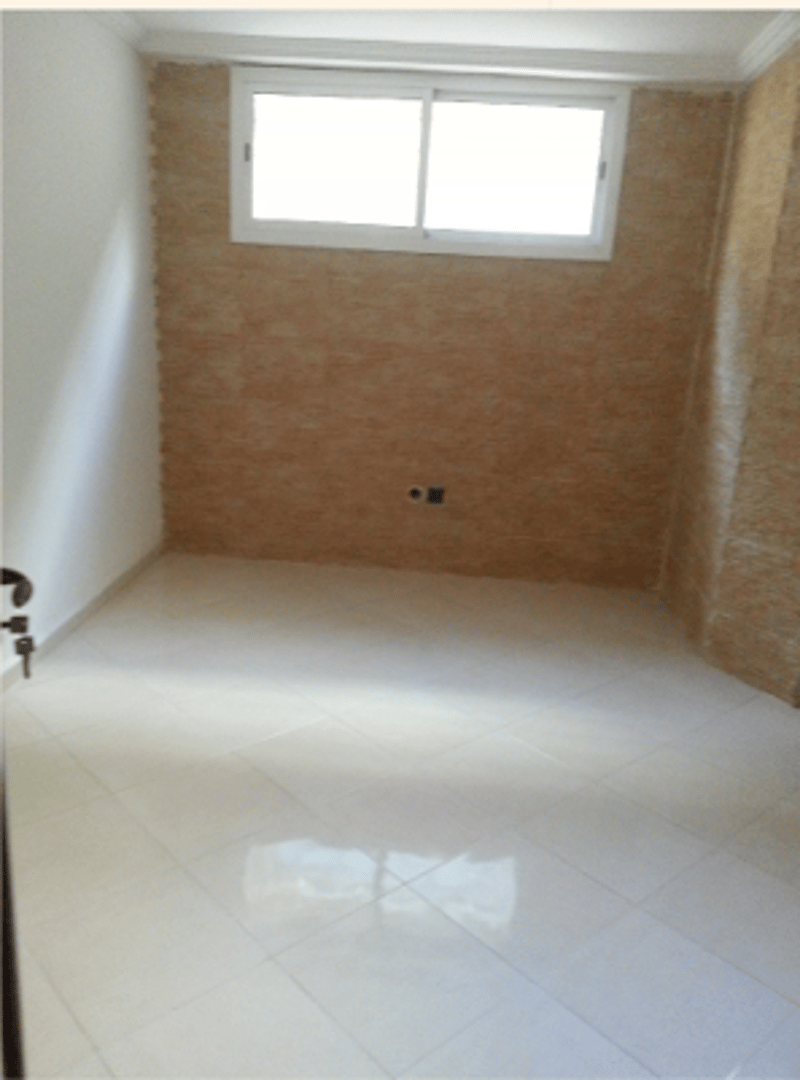 Empty room, white tiled floor, white walls, a window with a frame