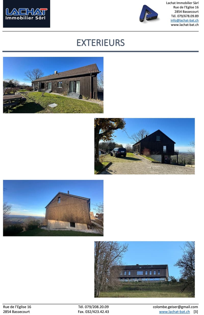 Wooden house, multiple windows, driveway, surrounded by grass and trees, mountain view