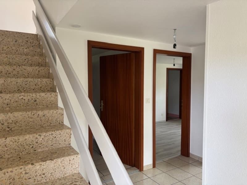 staircase, white walls, wooden doors, tiled floor