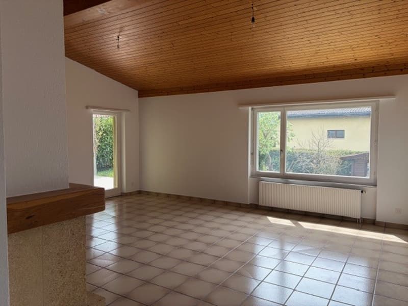 empty room, wooden ceiling, tiled floor, white walls, two windows, white radiator