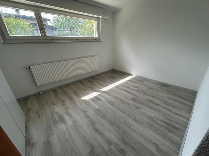 empty room, white walls, wooden floor, window, radiator