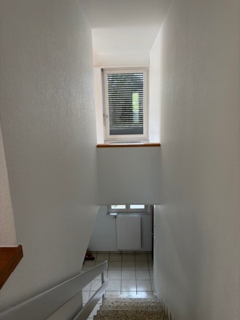 white walls, white tiles, white railing, window, radiator