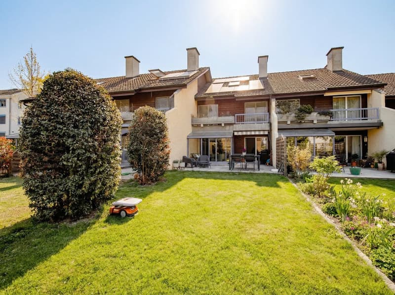 3 story house, brown roof, solar panels, wooden balcony, garden, outdoor seating