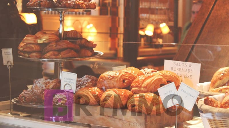 Croissants, bread, pastries, and other baked goods on display in a bakery