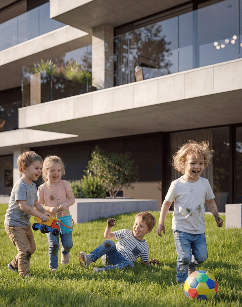 Modern building with glass walls, children playing in the grass, soccer ball