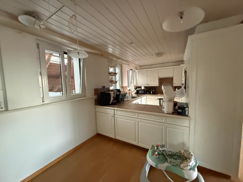 modern kitchen with white cabinets, wooden floor, white walls, windows, kitchen appliances