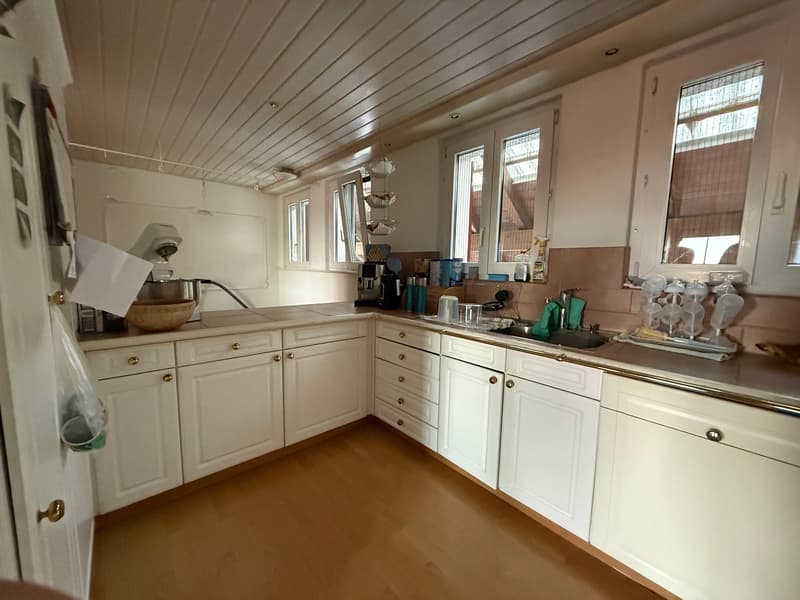 modern kitchen with white cabinets, wooden floor, sink, coffee machine, dishwasher, windows
