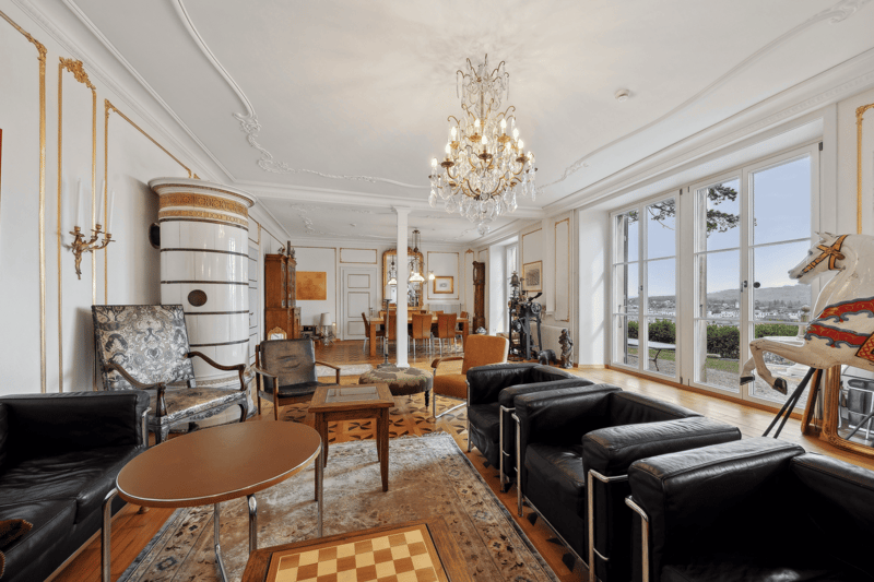 modern furniture, white walls, chandelier, wooden floor, fireplace, glass doors, view to the outside