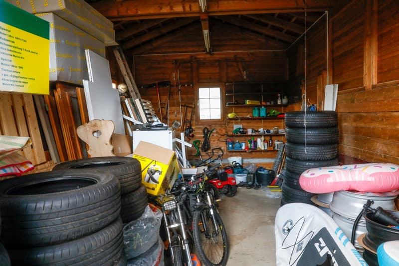 storage shed, several bicycles, tires, storage boxes, wooden shelves