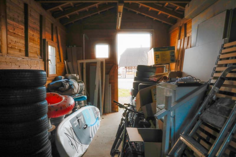 wooden walls, bicycle, storage boxes, inflatable floater, storage room
