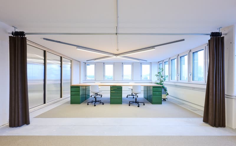 empty office with tables, large windows, brown curtains