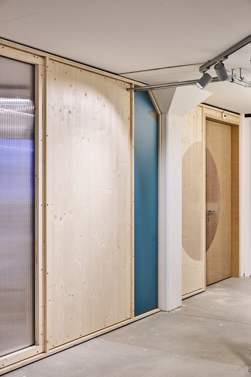 modern design with large wooden panels and glass doors, white ceiling, industrial light fixtures