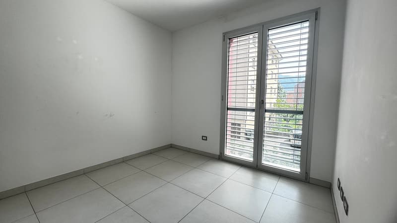 tiled floor, white walls, sliding door with window and balcony