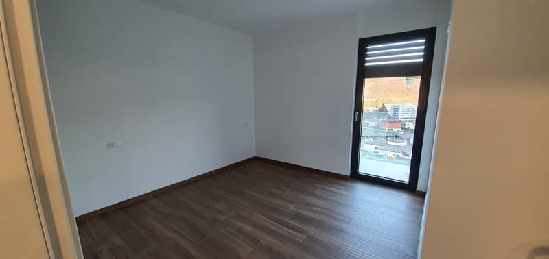 empty room, wooden floor, white walls, glass door, power outlet, view of the outside