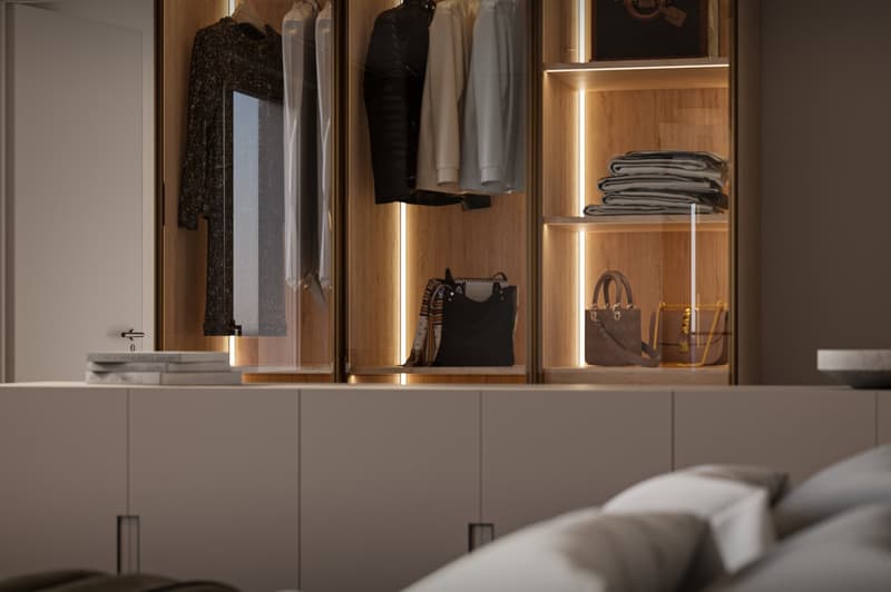 walk-in closet with LED lights, various clothes, handbags, and suitcases