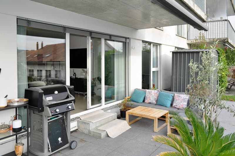 BBQ grill, wooden sofa, table, potted plants, tiles floor