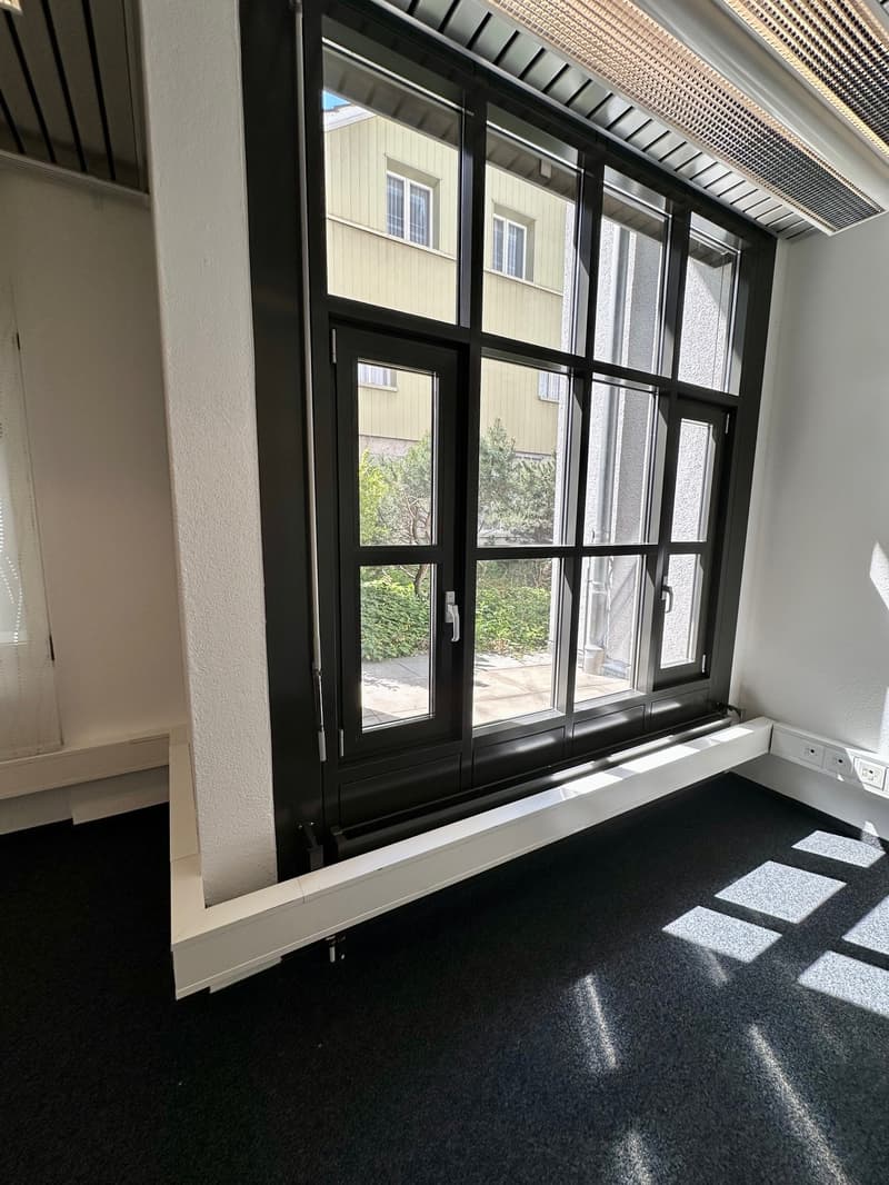empty room, large window, black frame, white walls, black carpet