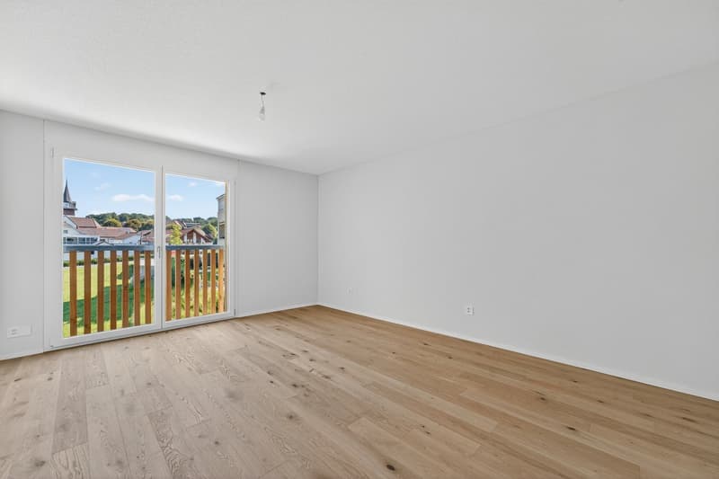 empty room, hardwood floors, sliding glass door to balcony, white walls