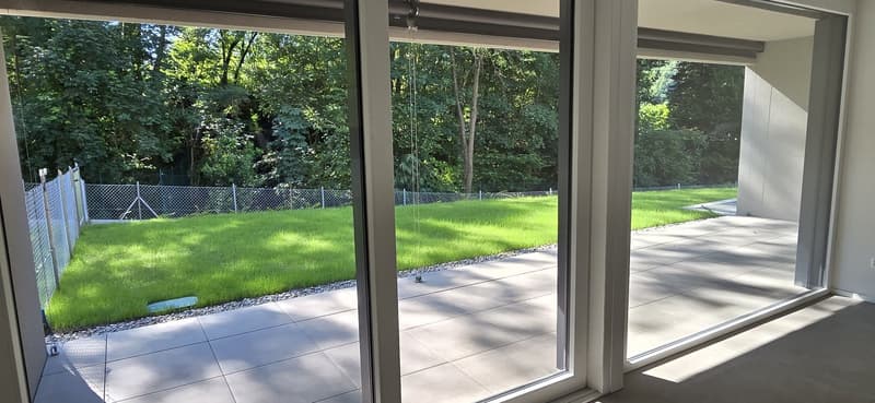 sliding glass doors, balcony, paved floor, lawn, fence, trees