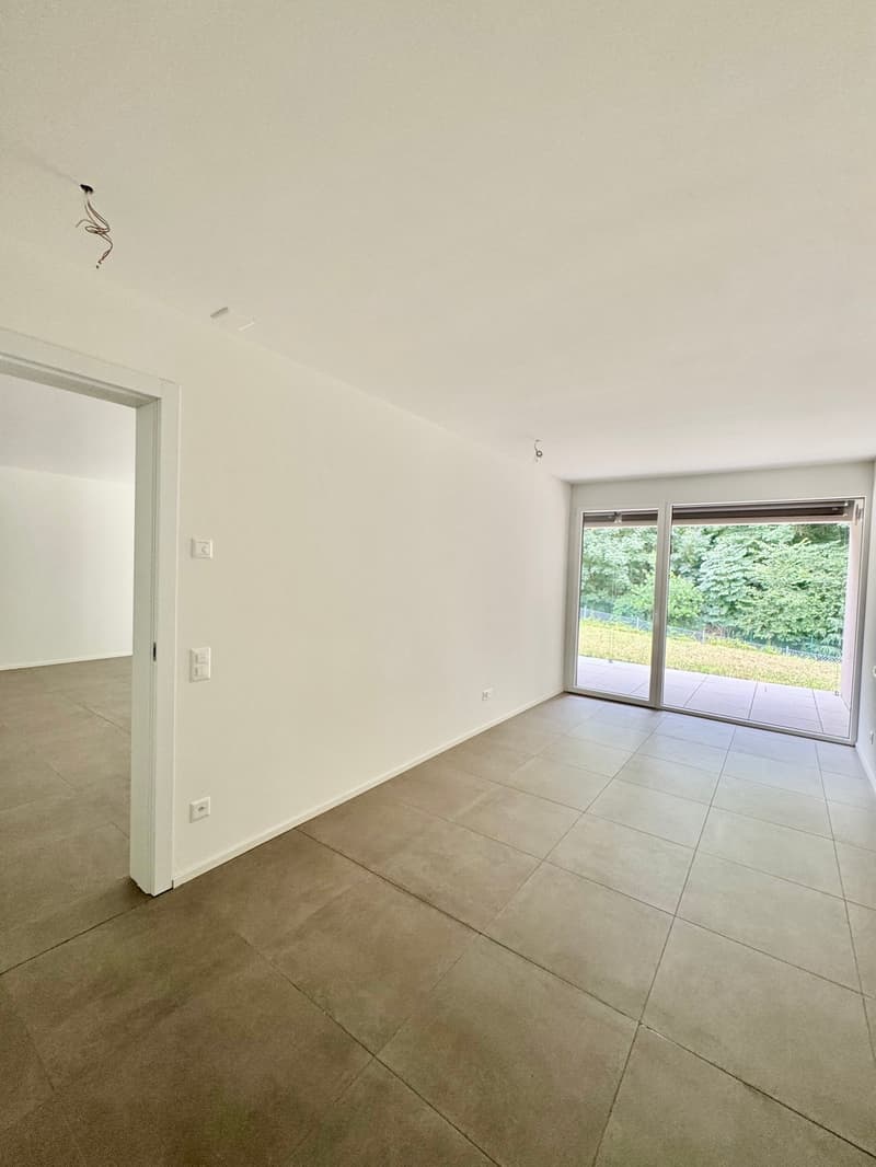 empty room, white walls, tiled floor, sliding glass doors, balcony, view of trees