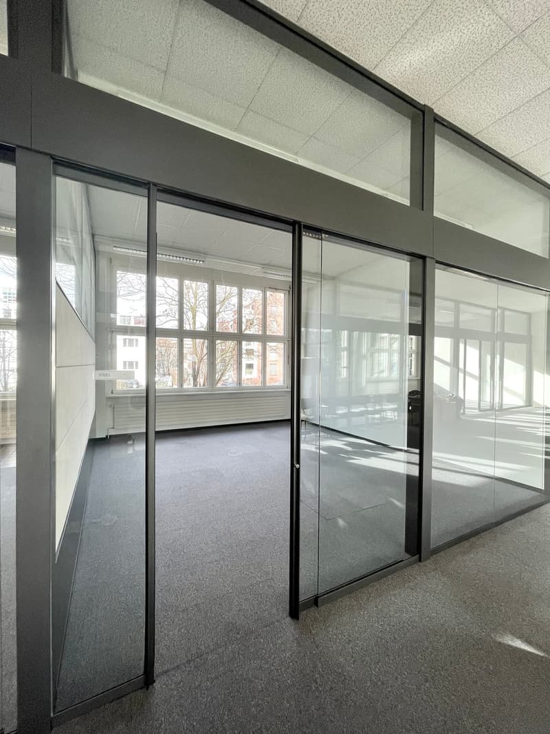 office space with large windows and sliding glass doors