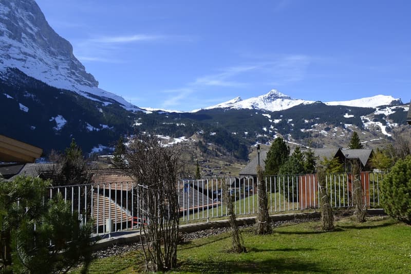 fenced garden with a view of the mountains