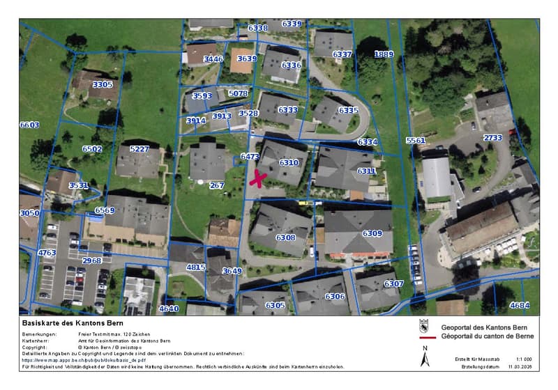residential area with multiple houses, parking lots, and a central road