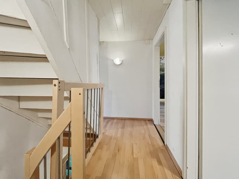 hardwood floor, light fixture, wooden staircase, white walls